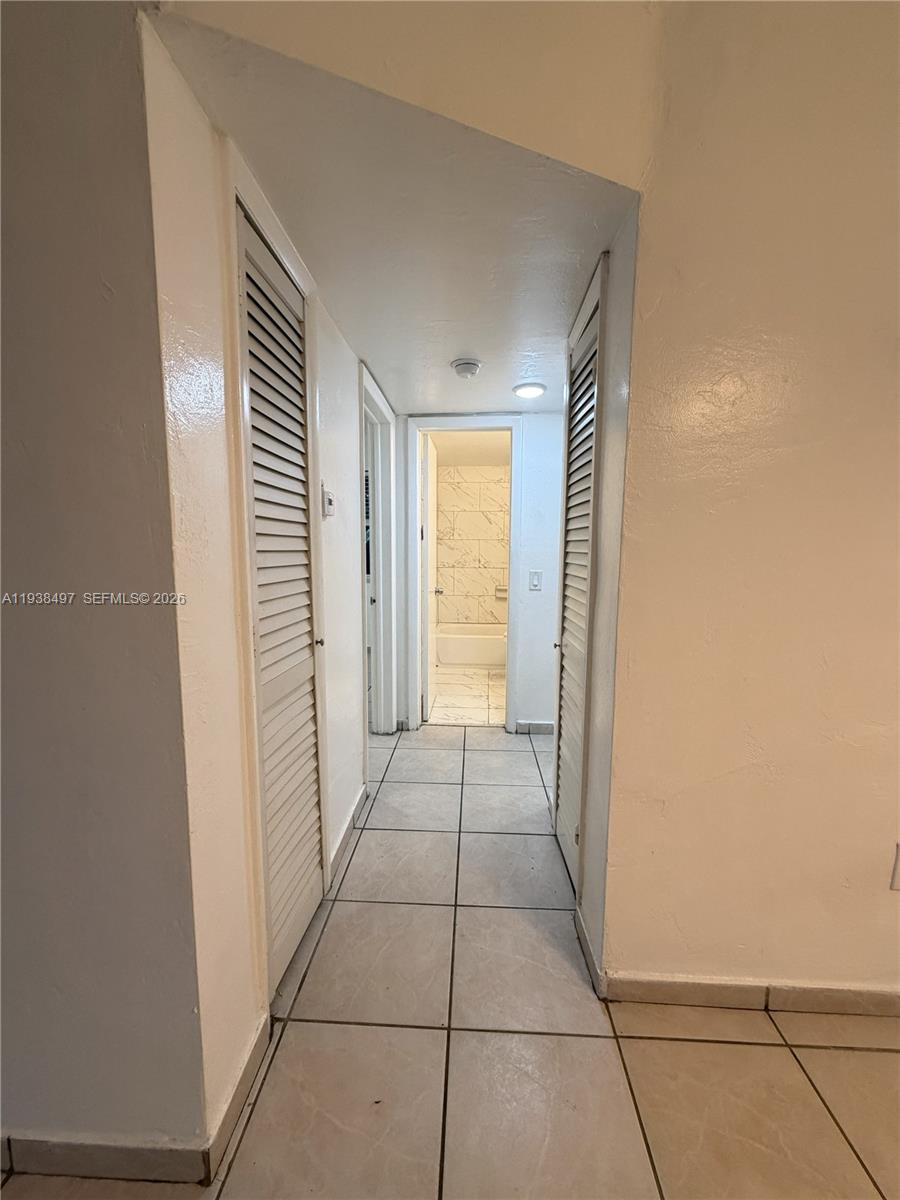 1860 Southwest 22nd Street, Unit 7 Miami, FL 33145 - Photo 6 of 8 a view of a room with an empty space and a window