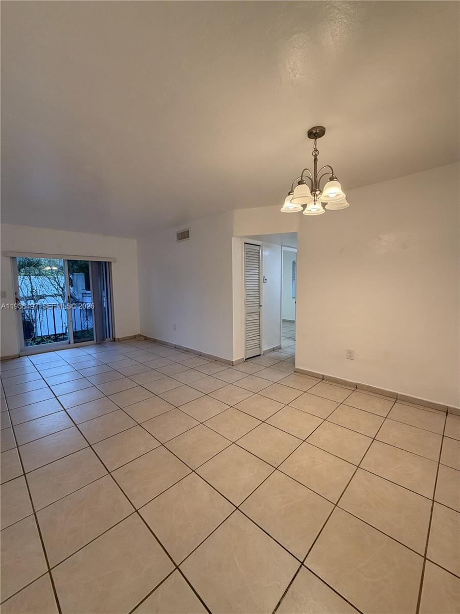 1860 Southwest 22nd Street, Unit 7 Miami, FL 33145 - Photo 8 of 8 a view of an empty room and chandelier fan