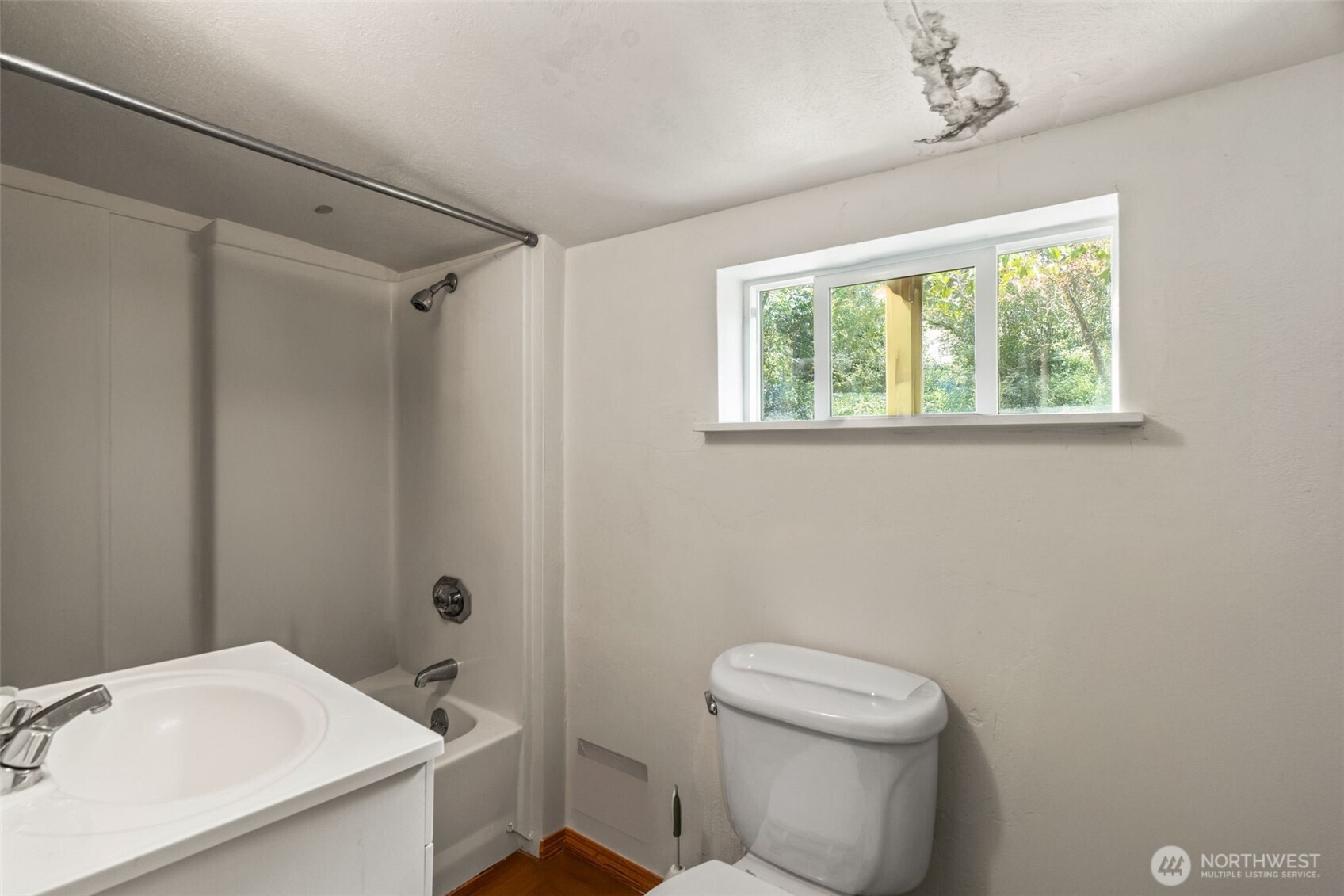 8011 South 128th Street Seattle, WA 98178 - Photo 6 of 15 a bathroom with a sink a toilet and a window