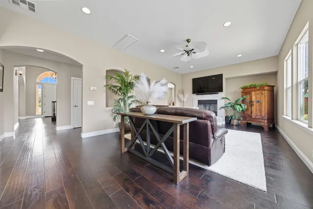 a dinning room with furniture a window and wooden floor