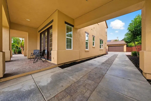 a view of a house with backyard and sitting area