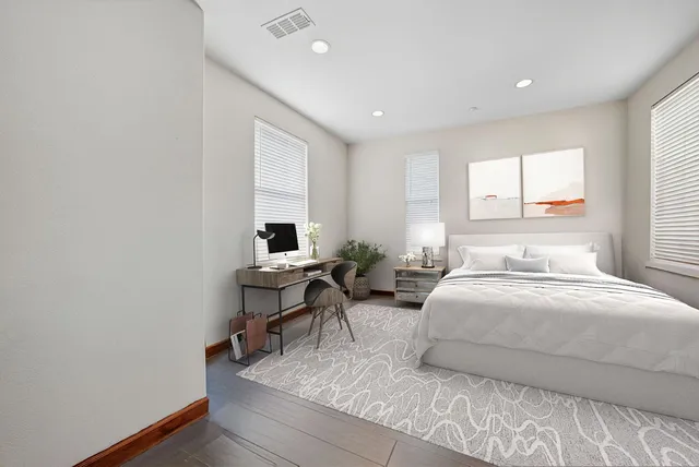 a bedroom with a bed and a table