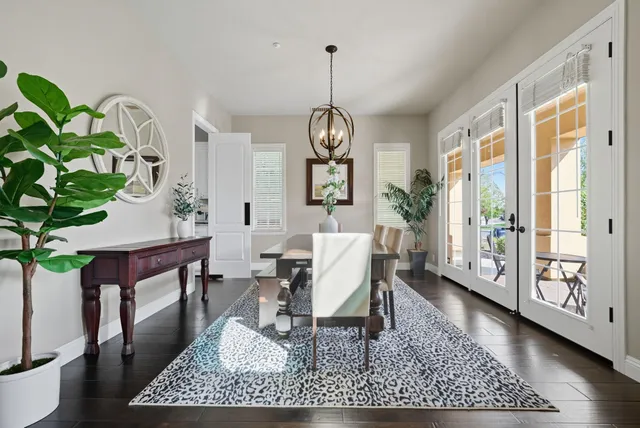 a living room with furniture a chandelier a rug and a window