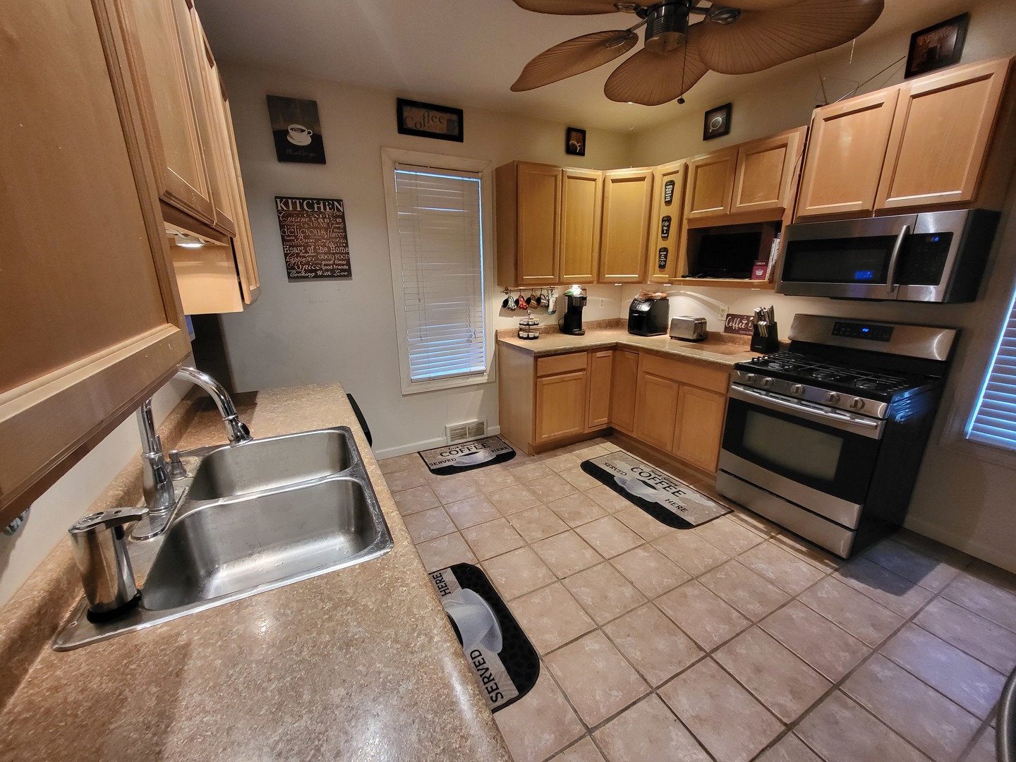 1204 North Center Street Joliet, IL 60435 - Photo 7 of 13 a kitchen with stainless steel appliances granite countertop a sink and cabinets