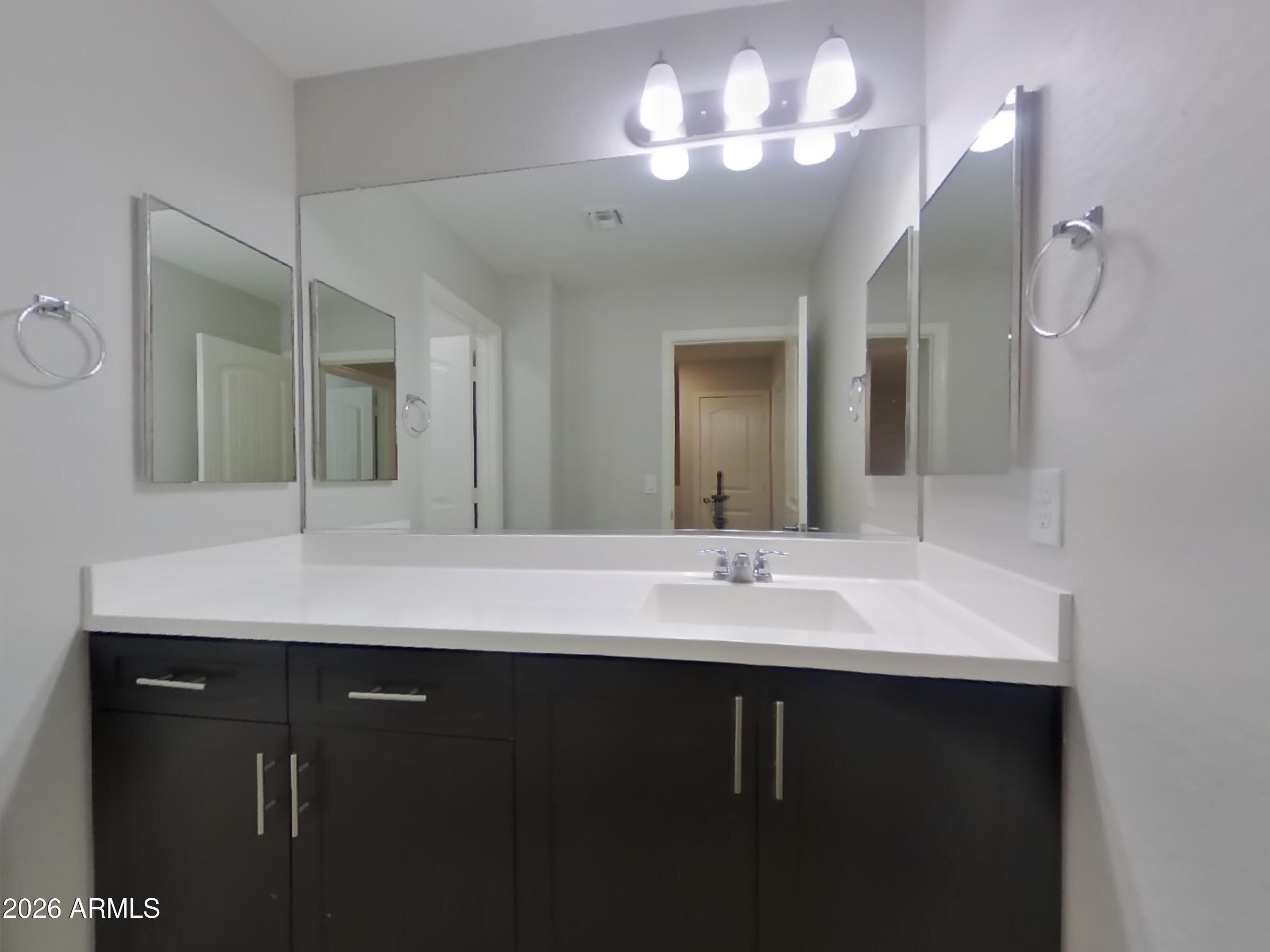 12577 West Steed Ridge Peoria, AZ 85383 - Photo 15 of 17 a bathroom with a sink double vanity and a mirror