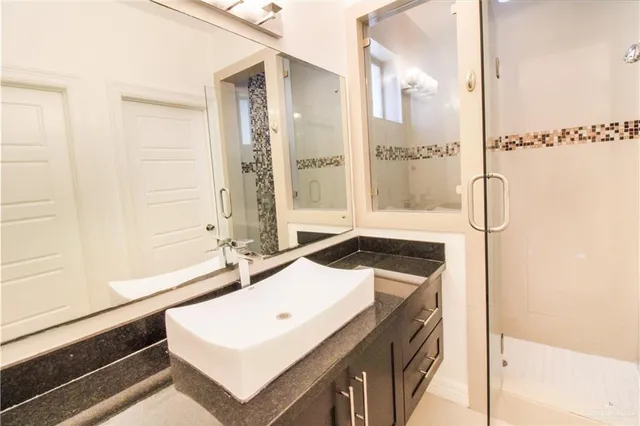 a bathroom with a tub sink and mirror