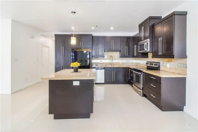 a kitchen with counter top space cabinets and stainless steel appliances
