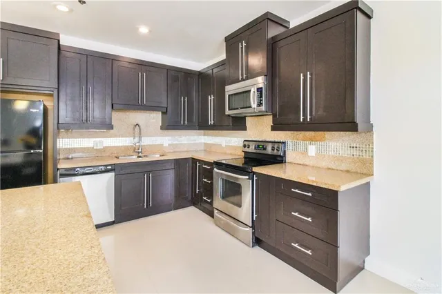 a kitchen with a sink stove and microwave