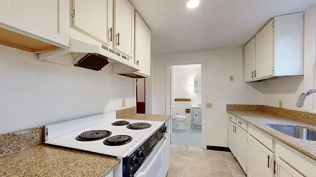 a kitchen with a stove and a sink