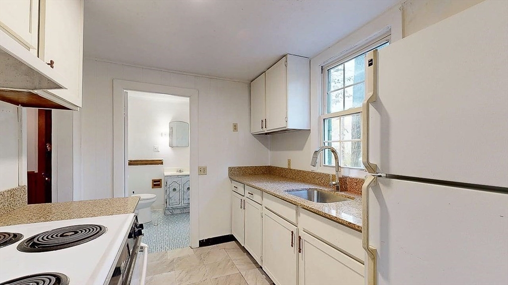 450 Mt Wayte Avenue Framingham, MA 01702 - Photo 17 of 28 a kitchen that has a sink cabinets and a window