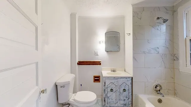 a bathroom with a sink a toilet and shower curtain