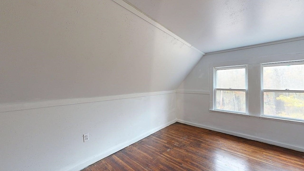 450 Mt Wayte Avenue Framingham, MA 01702 - Photo 21 of 28 an empty room with wooden floor and windows