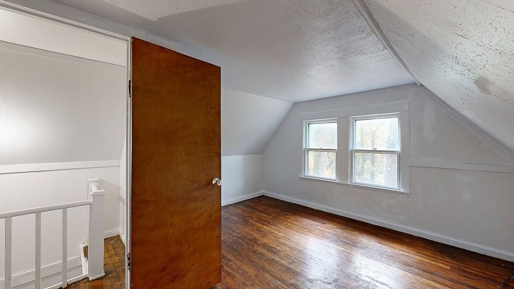 450 Mt Wayte Avenue Framingham, MA 01702 - Photo 23 of 28 a view of an empty room with wooden floor and a window