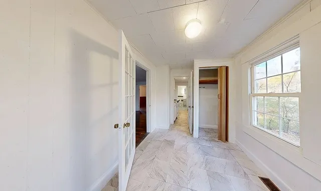 an empty room with windows and closet