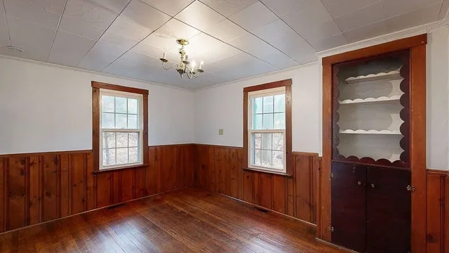 an empty room with windows and closet