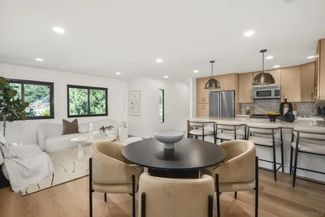 a kitchen with kitchen island granite countertop a table and chairs