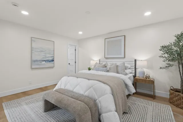 a bedroom with a bed and a night stand