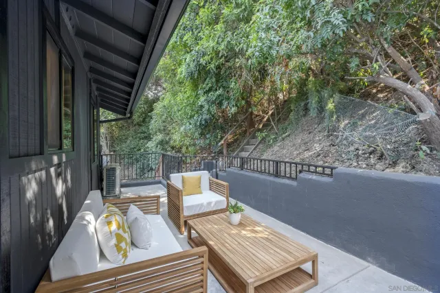 a view of balcony with wooden floor and outdoor seating