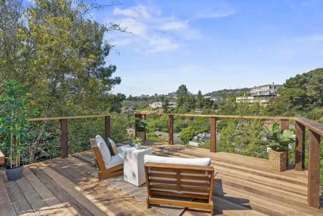 a view of a balcony with mountain view and wooden floor