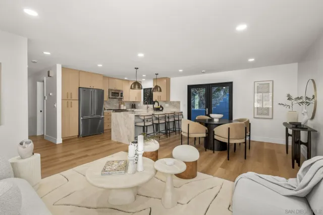 a living room with lots of furniture and kitchen view