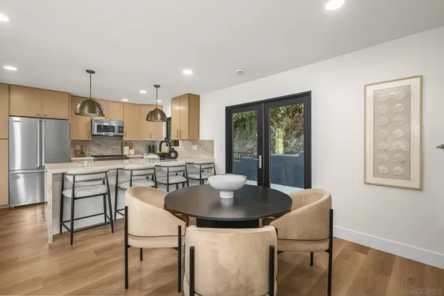 a kitchen with kitchen island a dining table and chairs