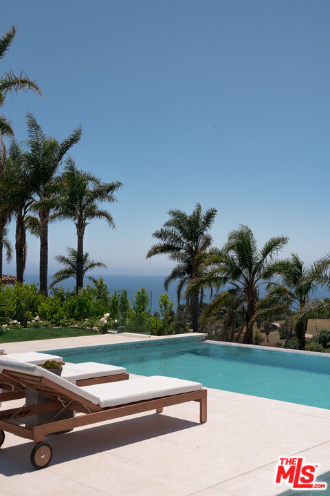 5819 Filaree Heights Road Malibu, CA 90265 - Photo 15 of 41 a view of swimming pool with a yard and potted plants