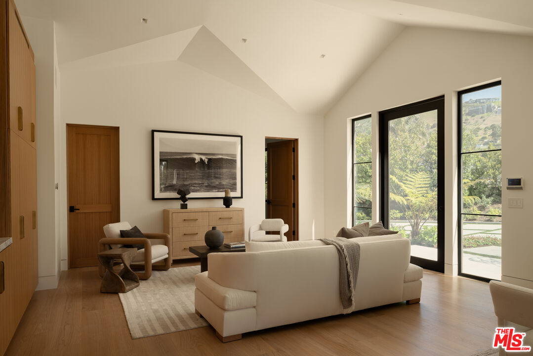 5819 Filaree Heights Road Malibu, CA 90265 - Photo 31 of 41 a living room with furniture and large windows