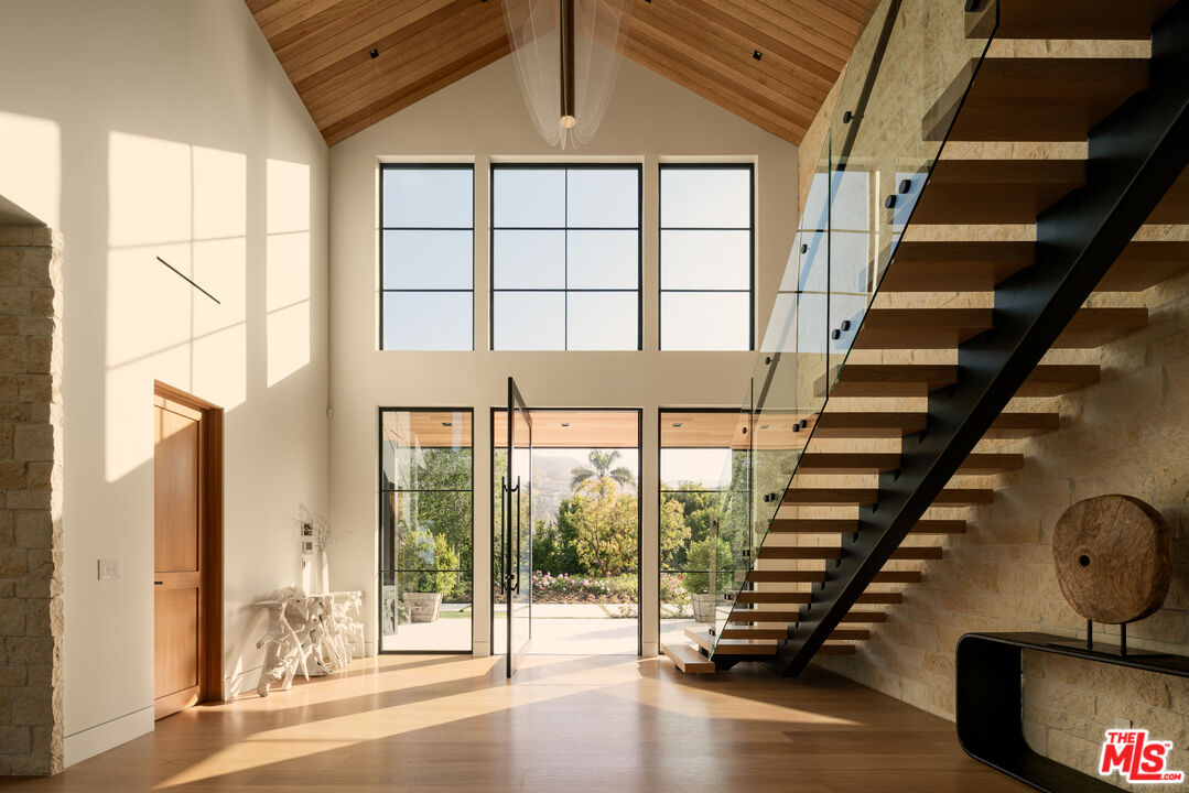 5819 Filaree Heights Road Malibu, CA 90265 - Photo 7 of 41 an empty room with wooden floor and windows