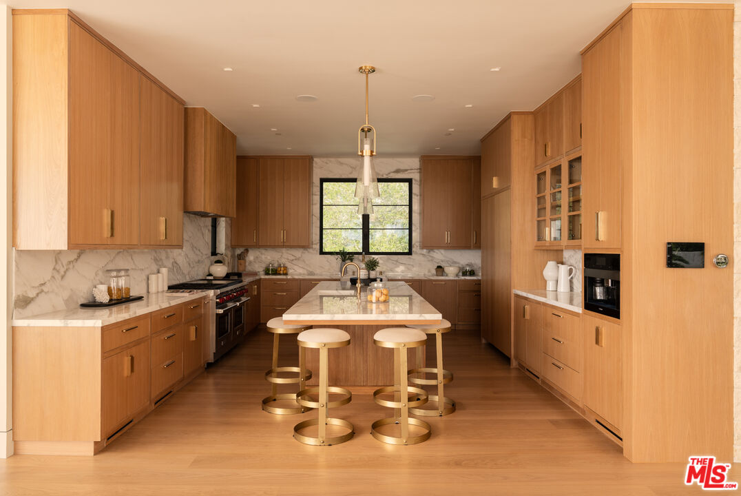 5819 Filaree Heights Road Malibu, CA 90265 - Photo 10 of 41 a large kitchen with a counter space a sink stainless steel appliances and cabinets