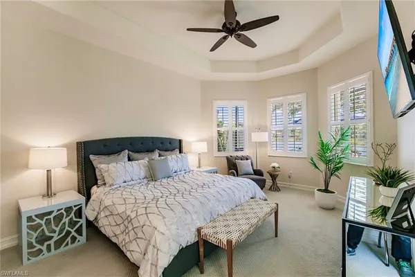 a bedroom with bed and a potted plant