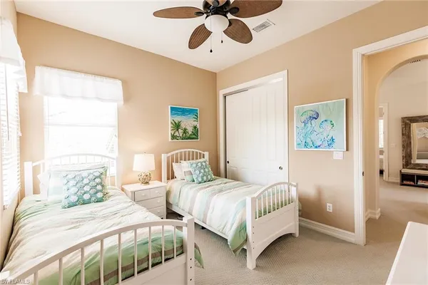 a bedroom with two beds and painting on the wall