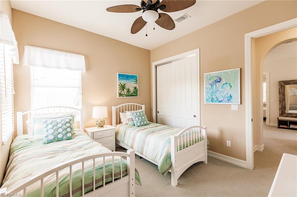 7797 Ashton Road Naples, FL 34113 - Photo 24 of 50 a bedroom with two beds and painting on the wall