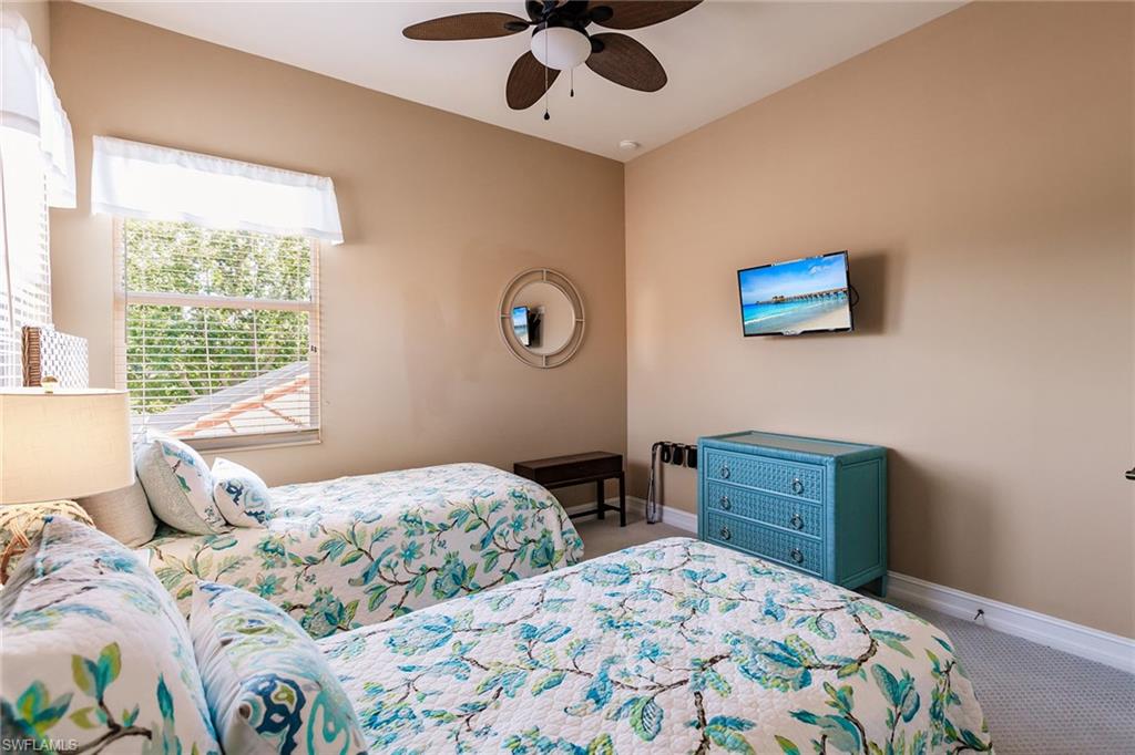 7797 Ashton Road Naples, FL 34113 - Photo 26 of 50 a bedroom with a bed and a window