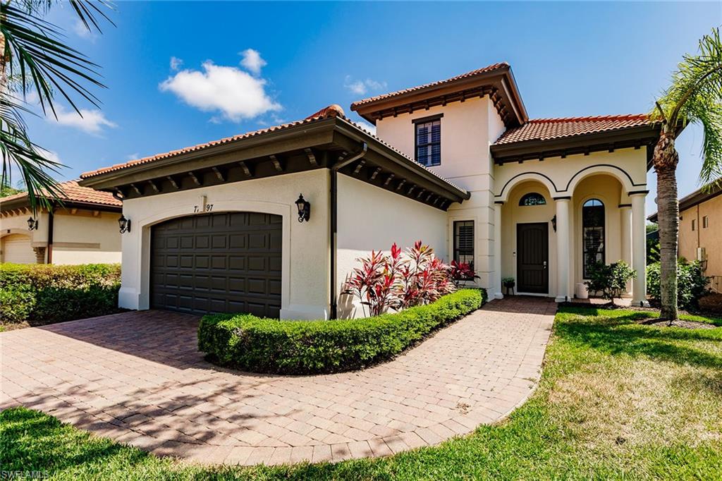 7797 Ashton Road Naples, FL 34113 - Photo 3 of 50 a front view of a house with a yard