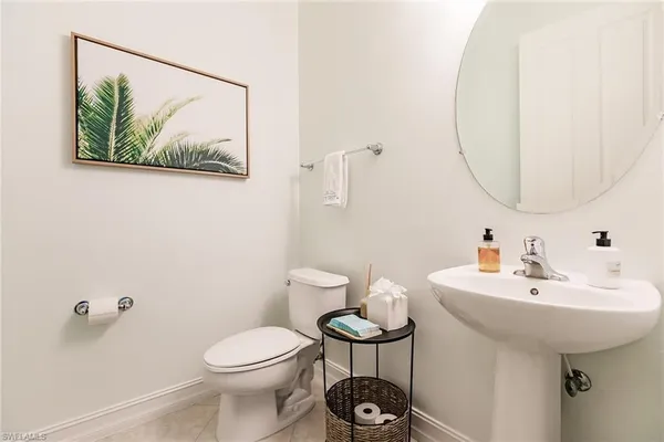 a bathroom with a sink mirror and toilet
