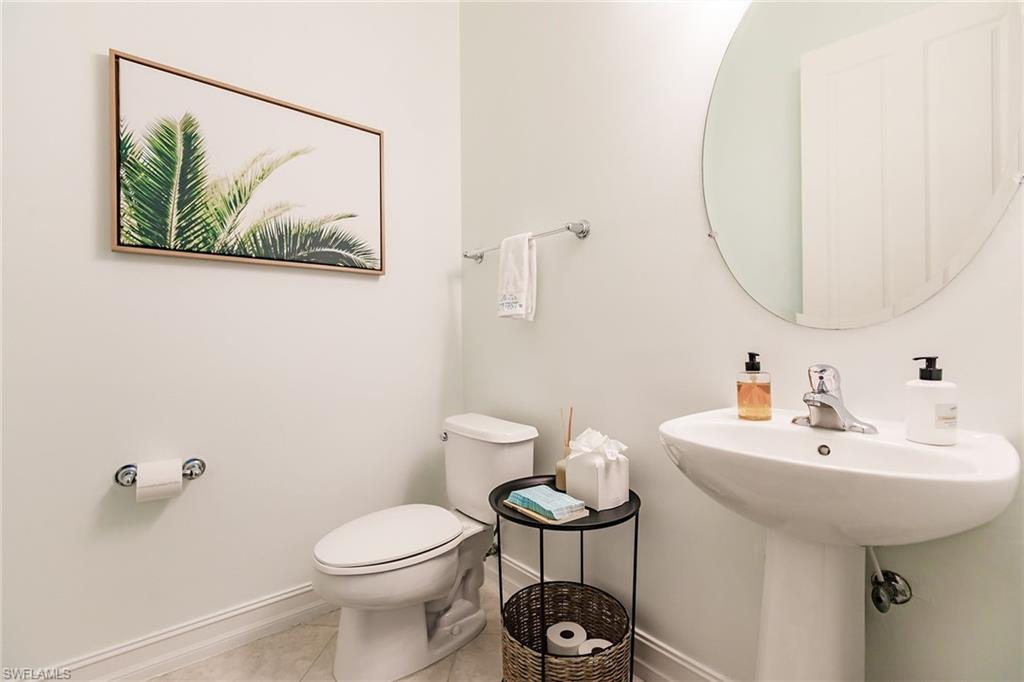 7797 Ashton Road Naples, FL 34113 - Photo 35 of 50 a bathroom with a sink mirror and toilet