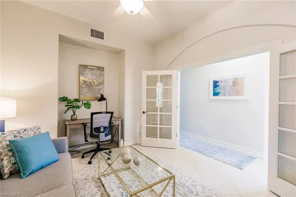 a view of a livingroom with workspace and a window