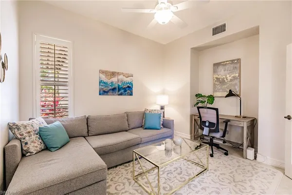 a living room with furniture and a window