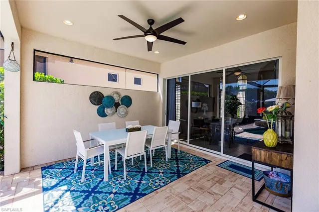 a dining room with furniture and a window