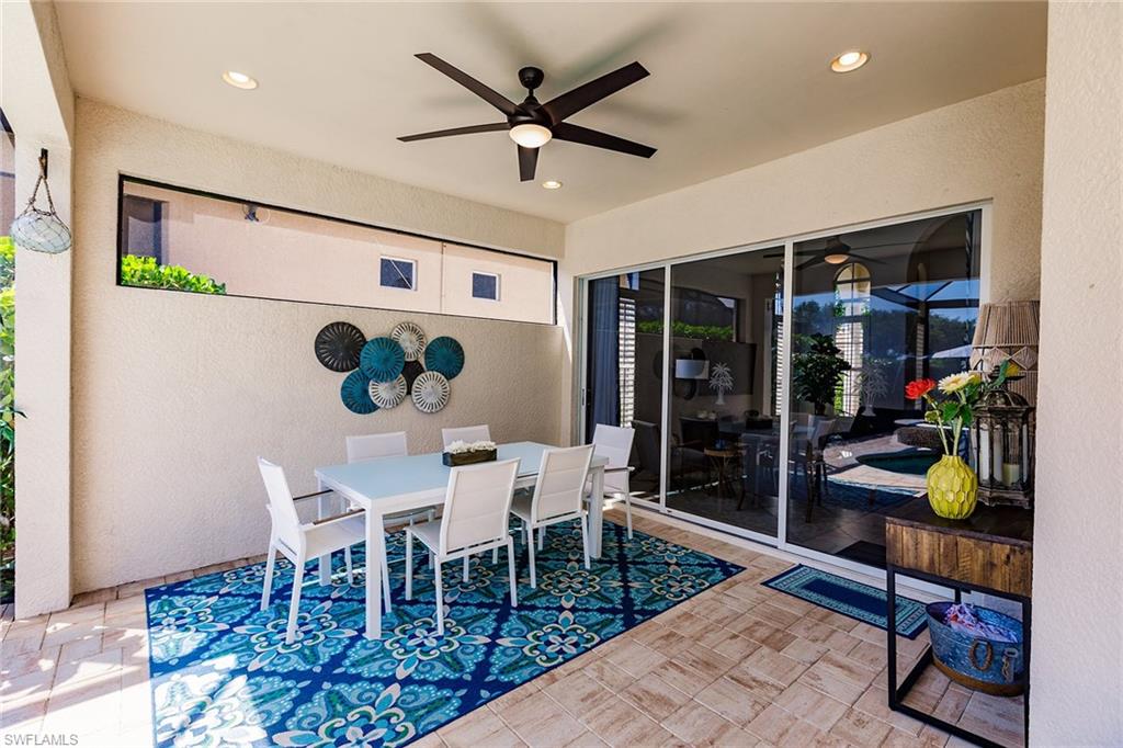 7797 Ashton Road Naples, FL 34113 - Photo 39 of 50 a dining room with furniture and a window