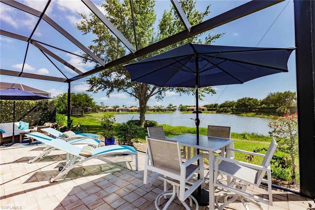 7797 Ashton Road Naples, FL 34113 - Photo 47 of 50 a view of a patio with a table chairs and a backyard