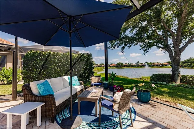 a view of a patio with couches under an umbrella