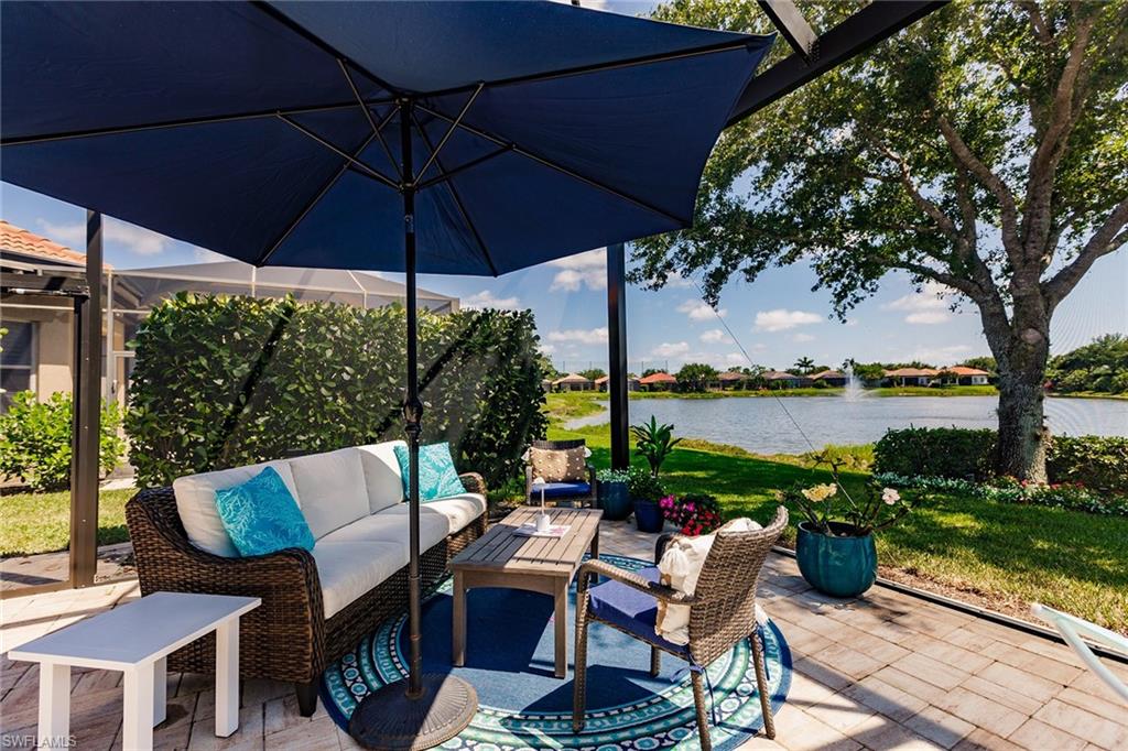 7797 Ashton Road Naples, FL 34113 - Photo 48 of 50 a view of a patio with couches under an umbrella