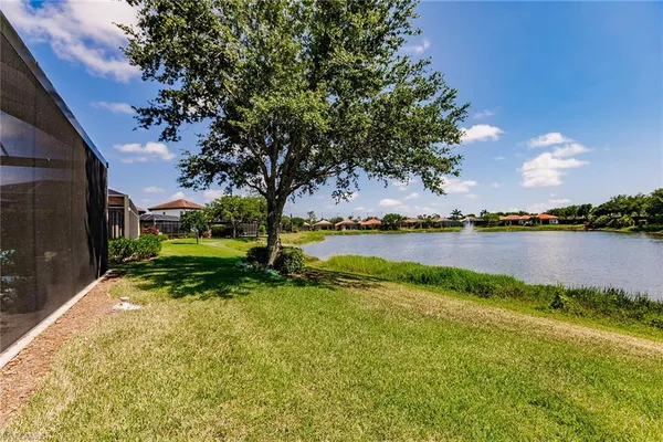 a view of a lake with houses in the back