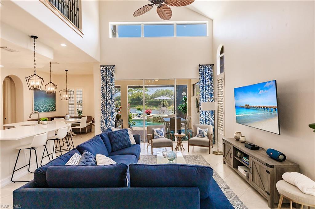 7797 Ashton Road Naples, FL 34113 - Photo 10 of 50 a living room with furniture and a flat screen tv