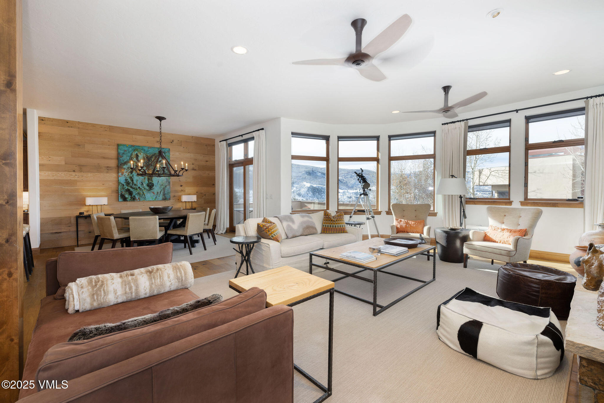 a living room with furniture and floor to ceiling windows