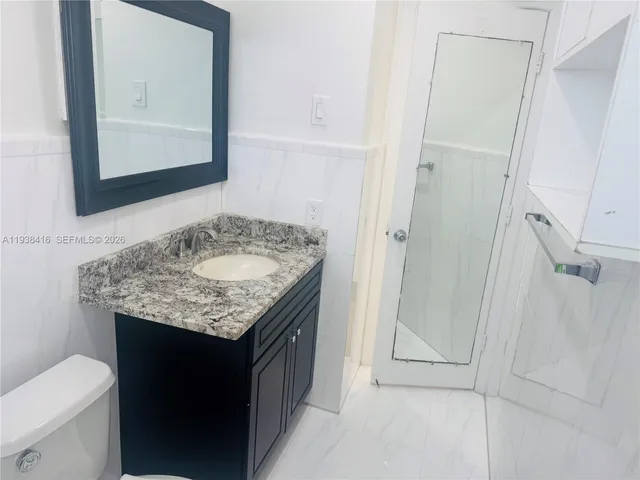 an empty room with fan and entrance