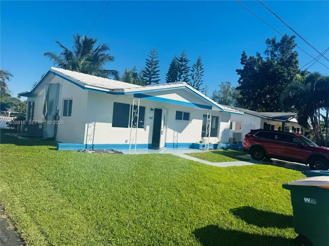 an empty room with a chandelier fan and windows