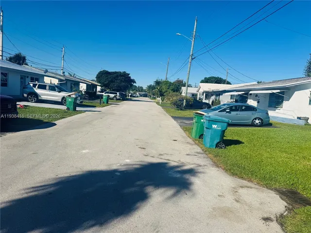 a kitchen with kitchen island granite countertop a sink a stove top oven a refrigerator and island