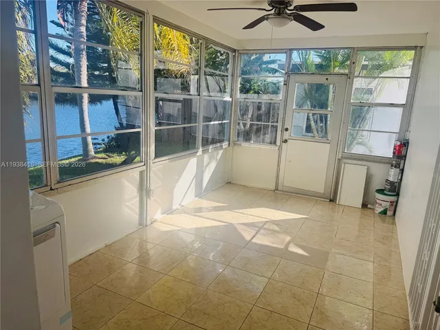 a view of a room with a tub and glass door